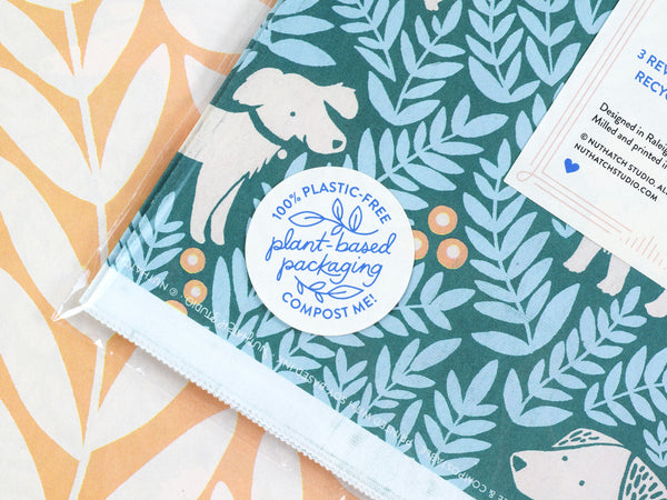 Close up view of a package label that reads “Plant-based packaging. 100% plastic free. Compost me!”