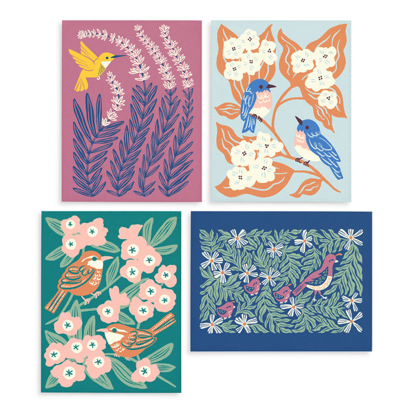 Four colorful greeting cards each with a different illustrated design of birds (hummingbird, bluebirds, wren, and quails) surrounded by leaves and flowers illustrated by Chrissie Van Hoever for Nuthatch Studio.