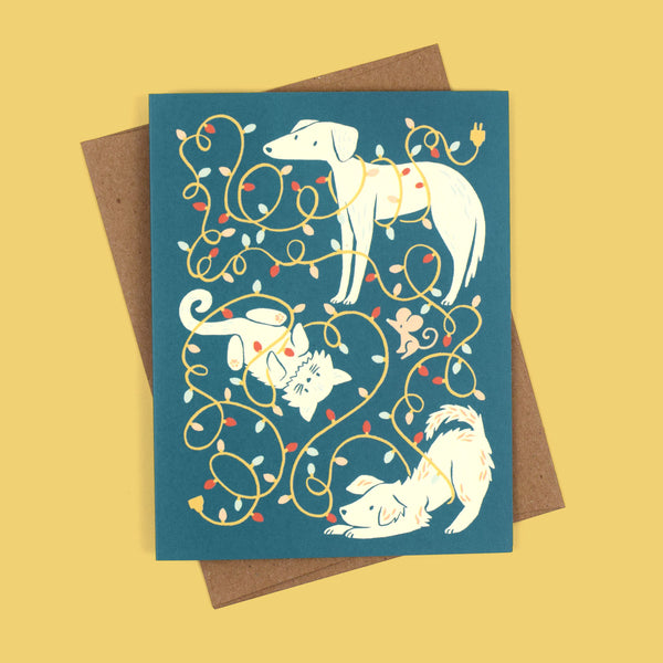 Greeting card with illustration of dogs and cat tangled up in Christmas lights