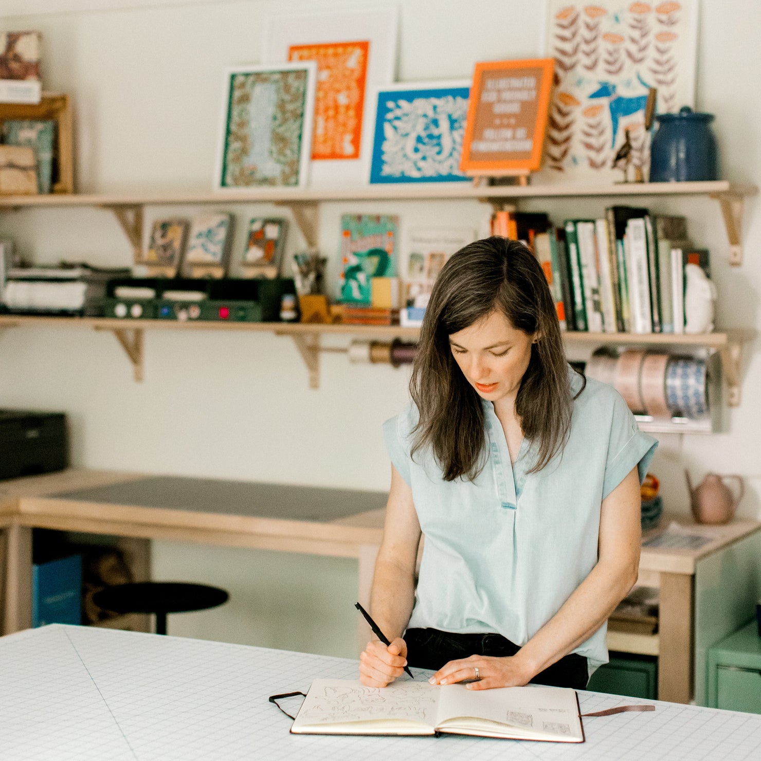 Chrissie Van Hoever of Nuthatch Studio drawing in her studio.