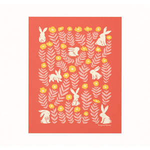 Archival art print of an illustration of bunnies in a field of yellow and pink marigolds on a coral backdrop.