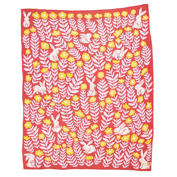 Throw size knit blanket illustrated with rabbits and flowers