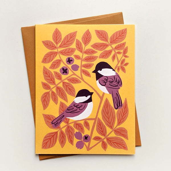 Illustrated greeting card with chickadees and hickory leaves on a cheery yellow background.