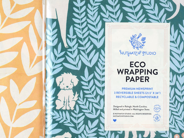 Close up view of the package label that reads “Eco Wrapping Paper. Premium Newsprint. 3 reversible sheets. Recyclable and compostable. Designed in Raleigh, NC. Milled and printed in Washington State.”