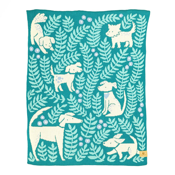 Crib/lap size knit blanket illustrated with dogs and leafy fronds