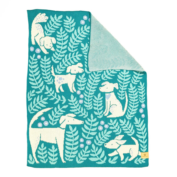 Crib/lap size knit blanket illustrated with dogs and leafy fronds