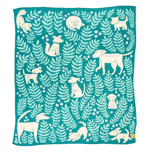 Throw size knit blanket illustrated with dogs and leafy fronds 