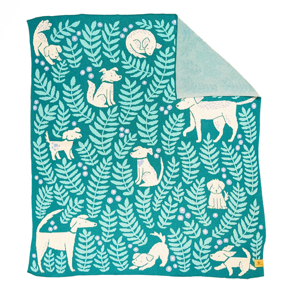 Throw size knit blanket illustrated with dogs and leafy fronds 
