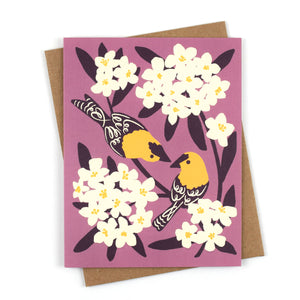 Illustrated greeting card with yellow goldfinches and white oleander blooms on a soft lavender background.