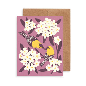 Illustrated greeting card with yellow goldfinches and white oleander blooms on a soft lavender background.