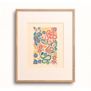 Jewel Garden Snakes art print displayed in a wooden frame.