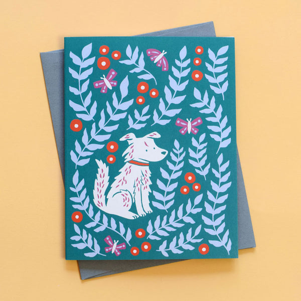 Greeting card with the illustration Molly Meadows by Chrissie Van Hoever featuring a sweet pup lounging in a meadow of blooms and butterflies.