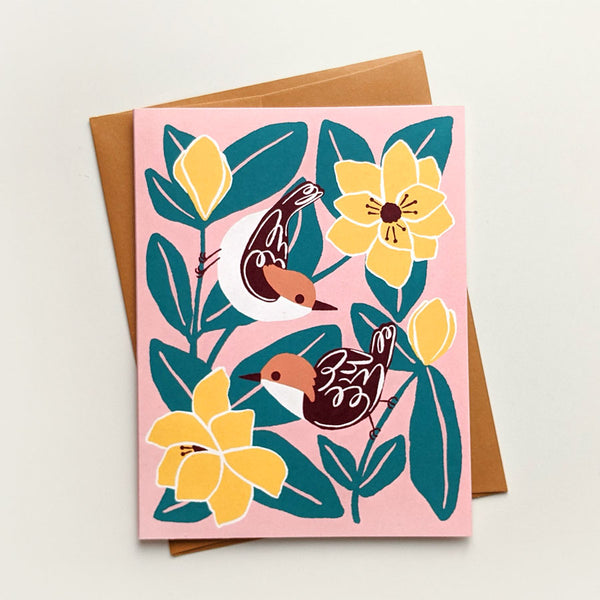 Illustrated greeting card with brown-headed nuthatches and big magnolia blooms on a dusty pink background.