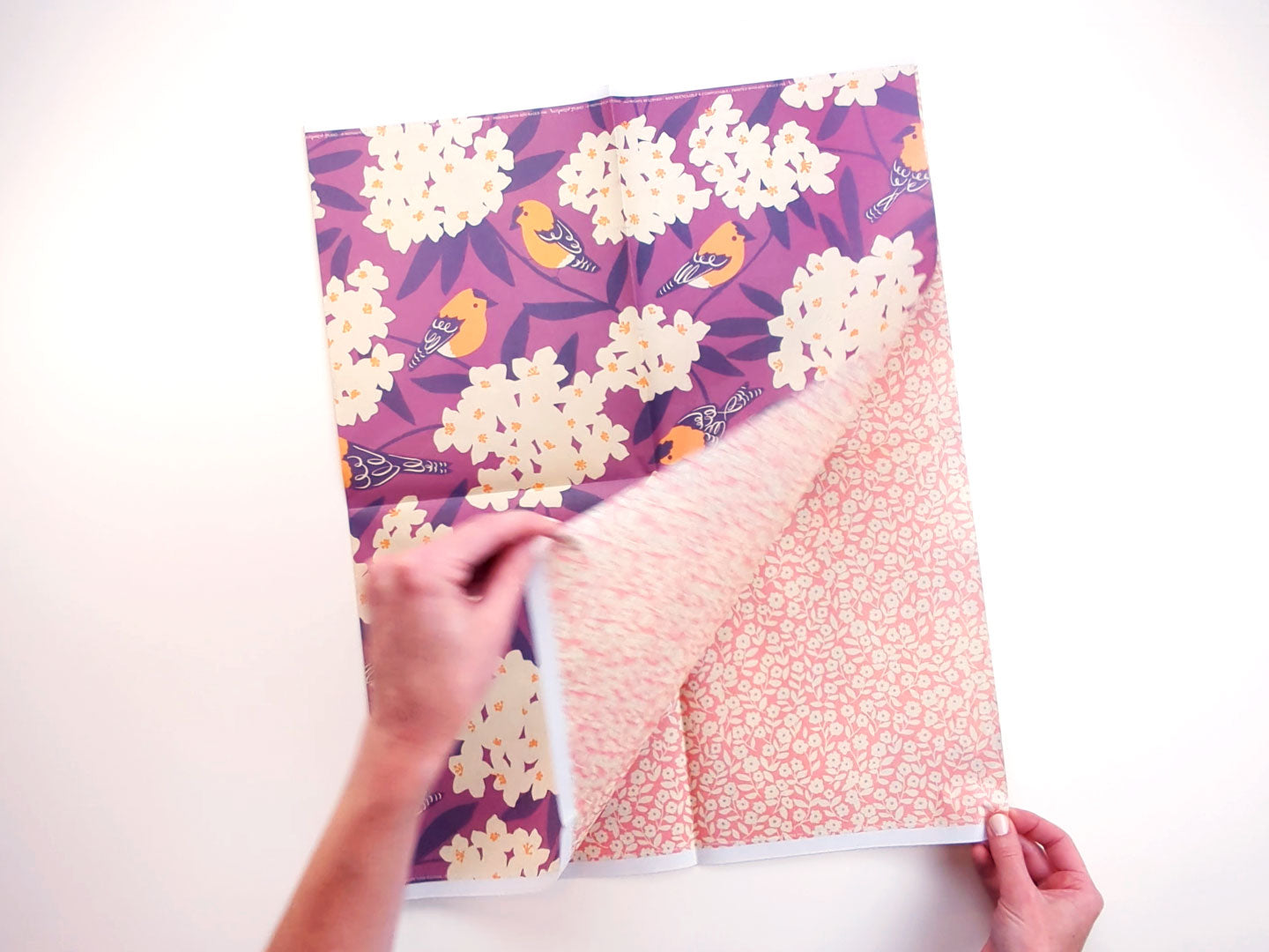 Video of unfolding a sheet of double-sided goldfinch gift wrap