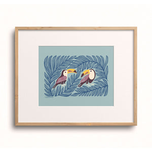 Toucan Pair art print displayed in a wooden frame.