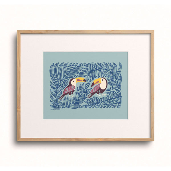 Toucan Pair art print displayed in a wooden frame.