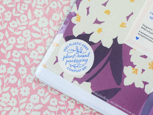 Close up view of a package label that reads “Plant-based packaging. 100% plastic free. Compost me!”