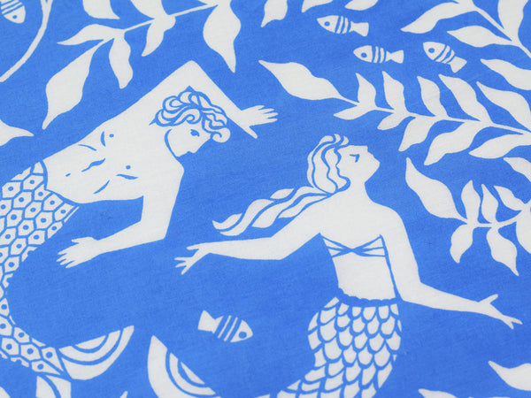 Close up view of merman and mermaid dancing surrounded by sea leaves and little fish.