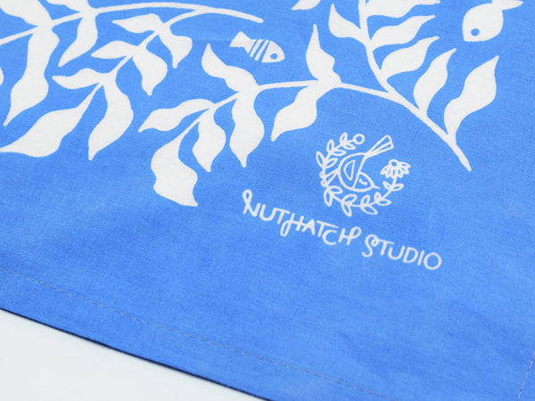 Close up view of the Nuthatch Studio logo in the corner of the bandana design.